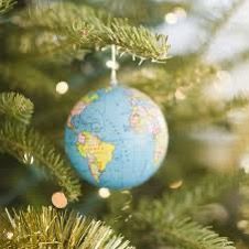 The globe as a bauble hanging from the branch of a Christmas tree.